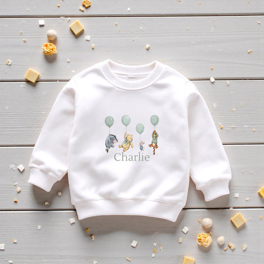 White personalised children’s sweatshirt with woodland friends balloon design and custom name printed beneath.