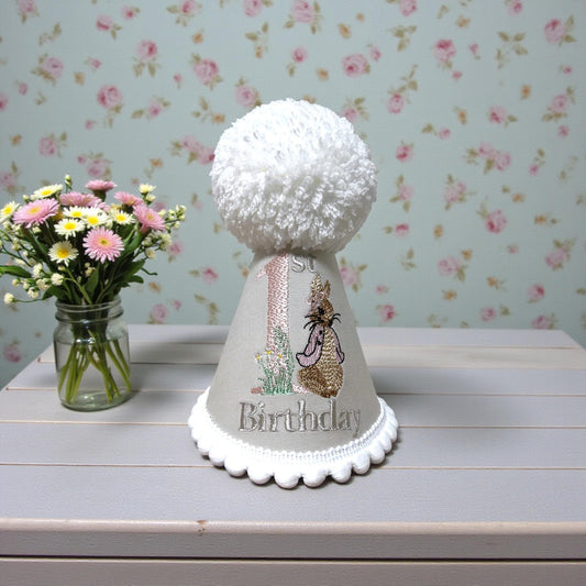 baby girls party hat - embroidered with child's birthday number. Cream base, white accents with bunny embroidery.