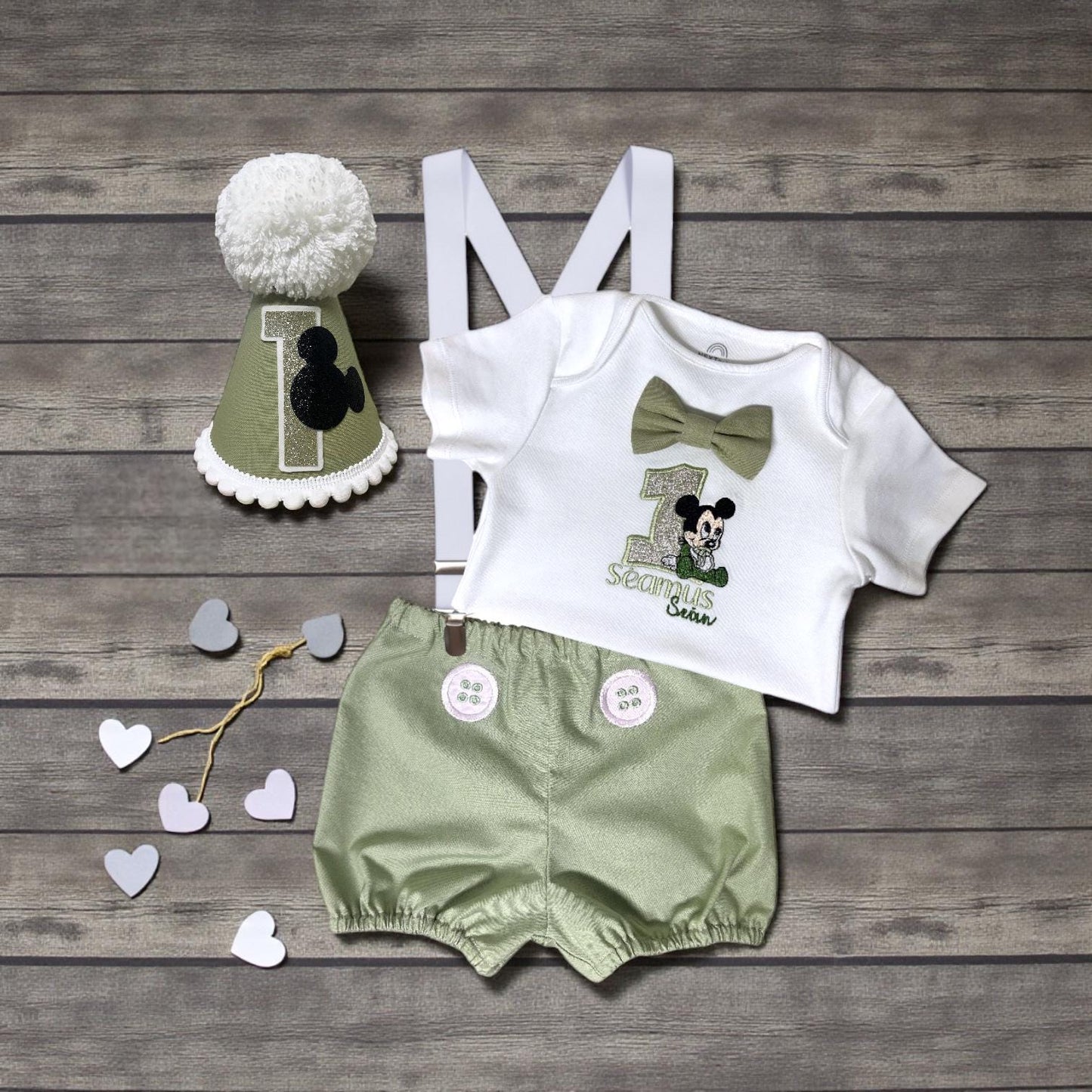 Cartoon mouse embroidered birthday outfit displayed with sage green bloomers and braces.