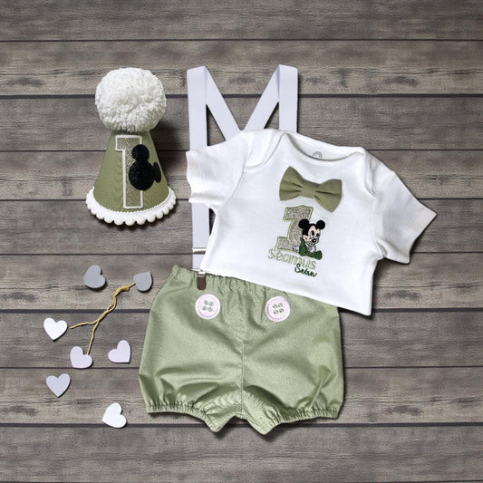 Cartoon mouse embroidered birthday outfit displayed with sage green bloomers and braces.