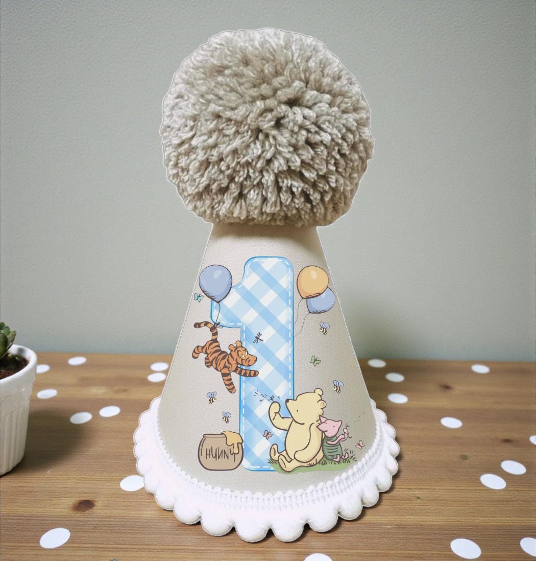 Classic honey bear first birthday party hat with blue pom pom