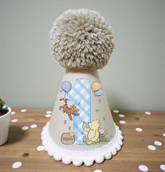 Classic honey bear first birthday party hat with blue pom pom