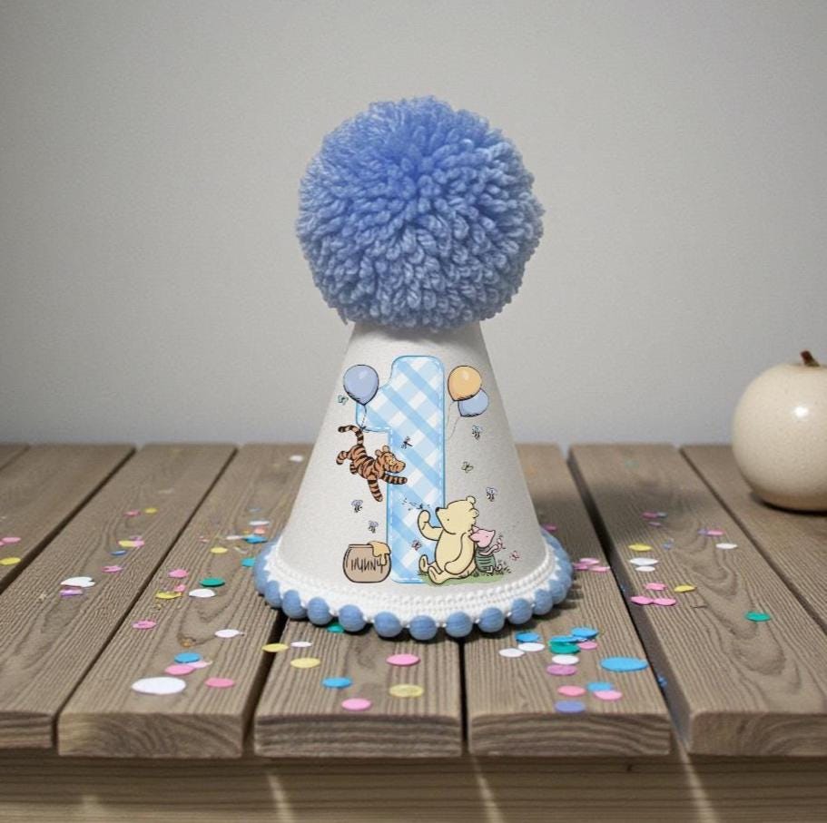 Classic honey bear first birthday party hat with blue pom pom