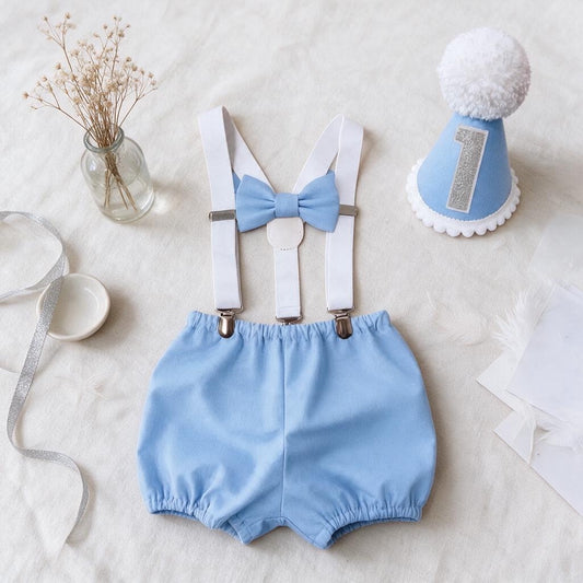 Waterfall light blue shorts and suspenders set - featuring a handmade blue party hat with white trims and a glitter birthday number, white suspender braces and a matching bow and shorts
