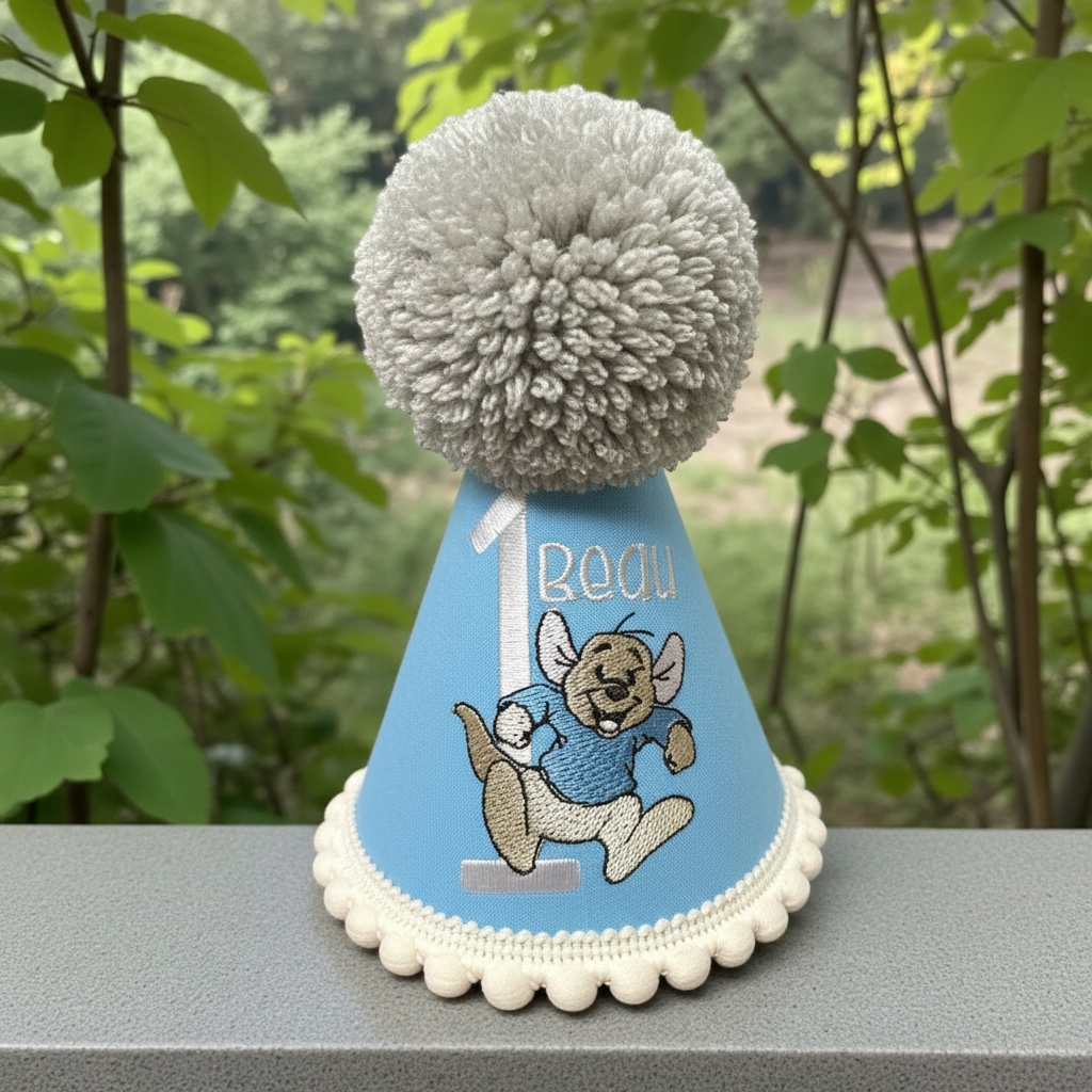 Light blue baby birthday hat with embroidered character and name
