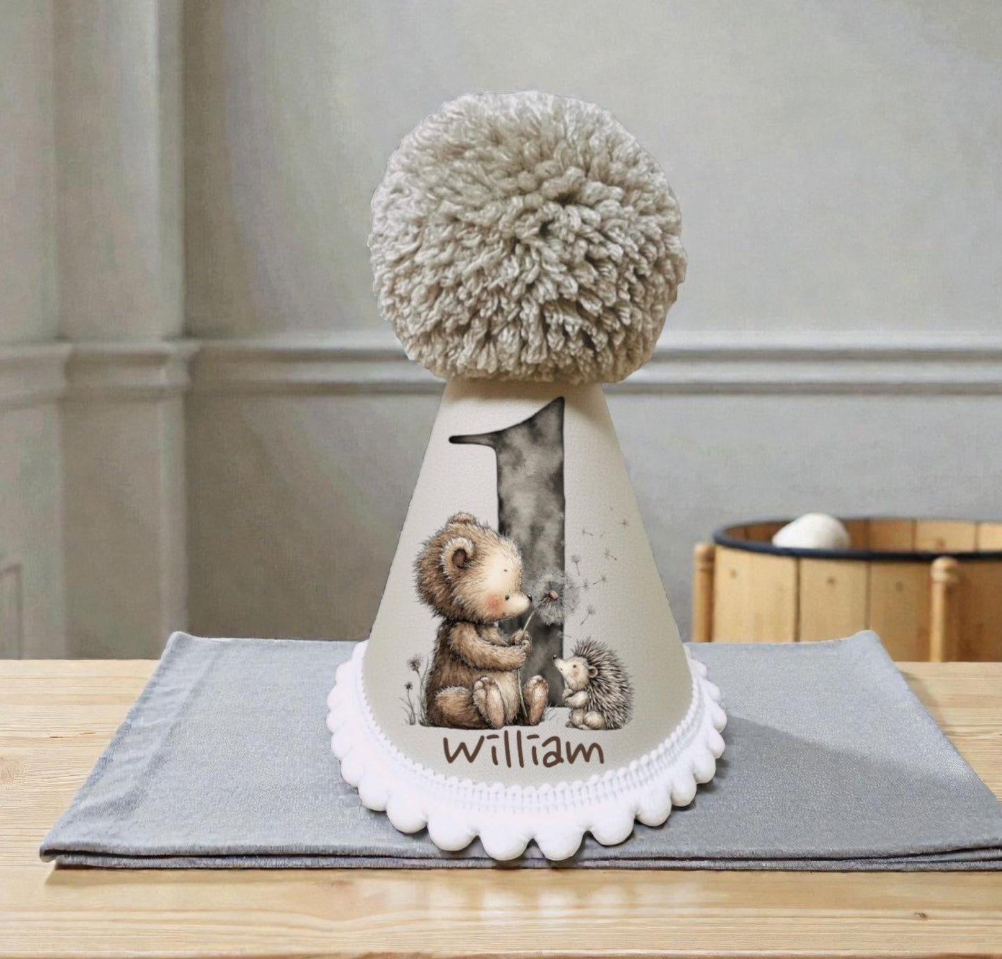 Personalised baby birthday hat with printed number one, woodland animals and child’s name
Handmade neutral birthday party hat with pom pom and white bobble trim