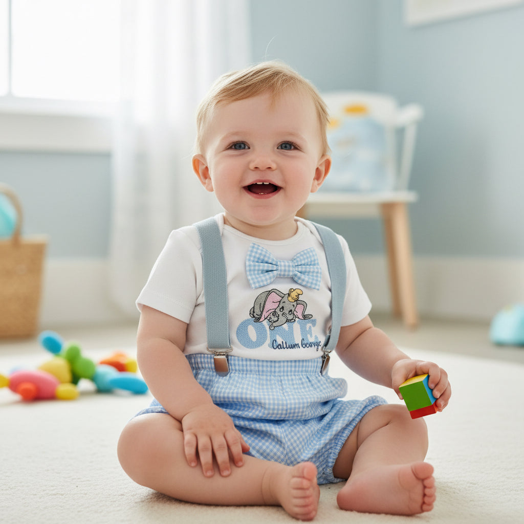 Baby sitting on a floor with colorful blocks, wearing a outfit with suspenders and a bow tie.