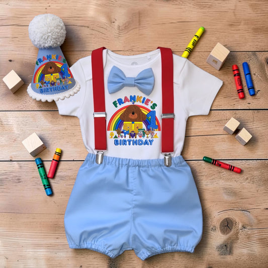 Personalised Hey Duggee baby boy birthday outfit with printed rainbow bodysuit, handmade blue bloomers, red braces and matching party hat.