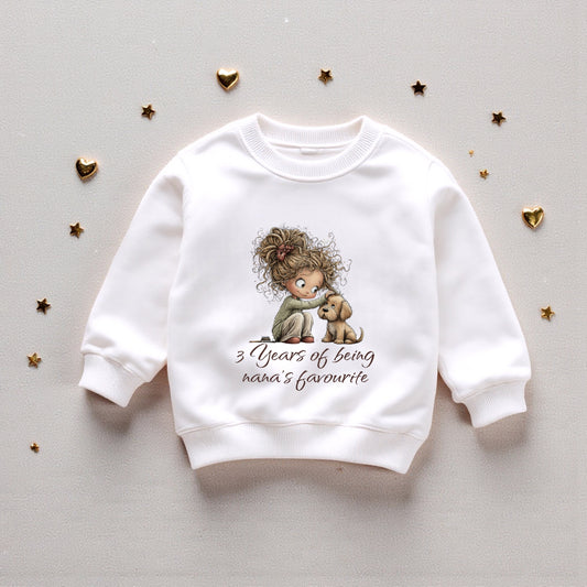 White sweatshirt with a child and dog illustration and text on a light gray background with gold heart decorations.