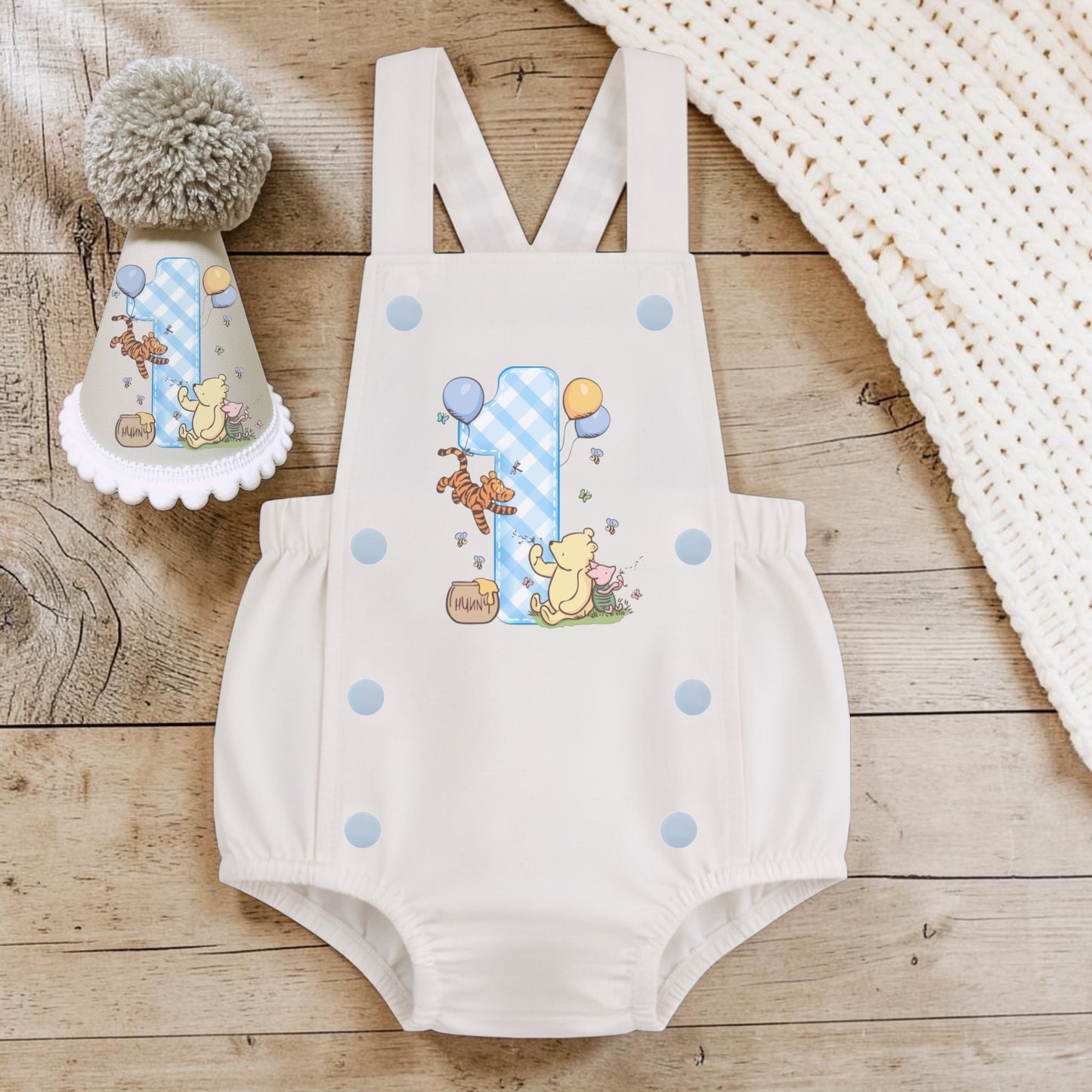 Classic Pooh baby boy first birthday romper with blue gingham number one and matching handmade cream birthday party hat